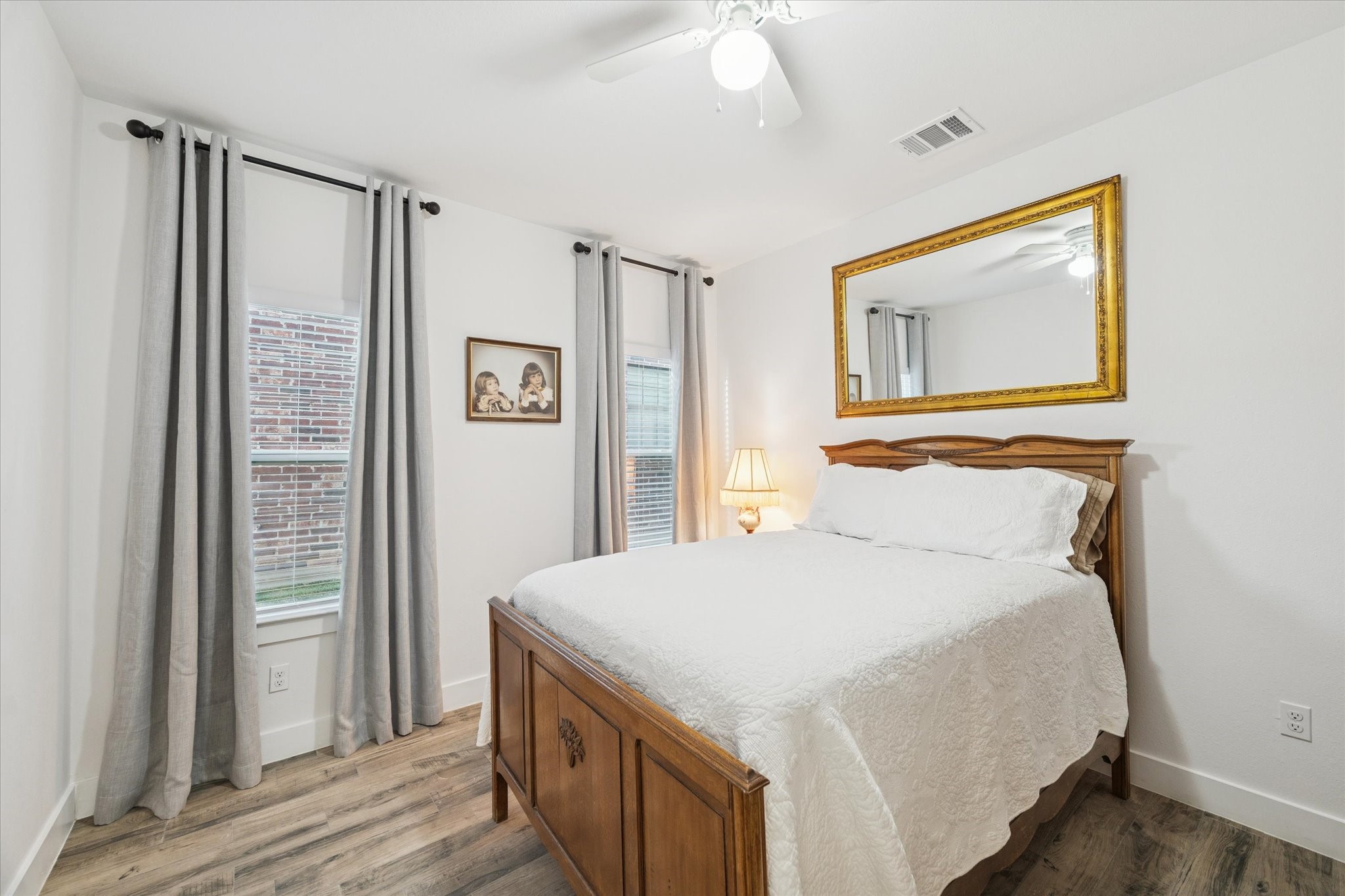 203 Hampton Glen Road Montgomery, TX 77356 - Photo 19 of 28 This secondary bedroom features abundant natural light, creating a peaceful and harmonious atmosphere. The spacious layout ensures comfort and privacy, making it an ideal retreat for family members or guests.