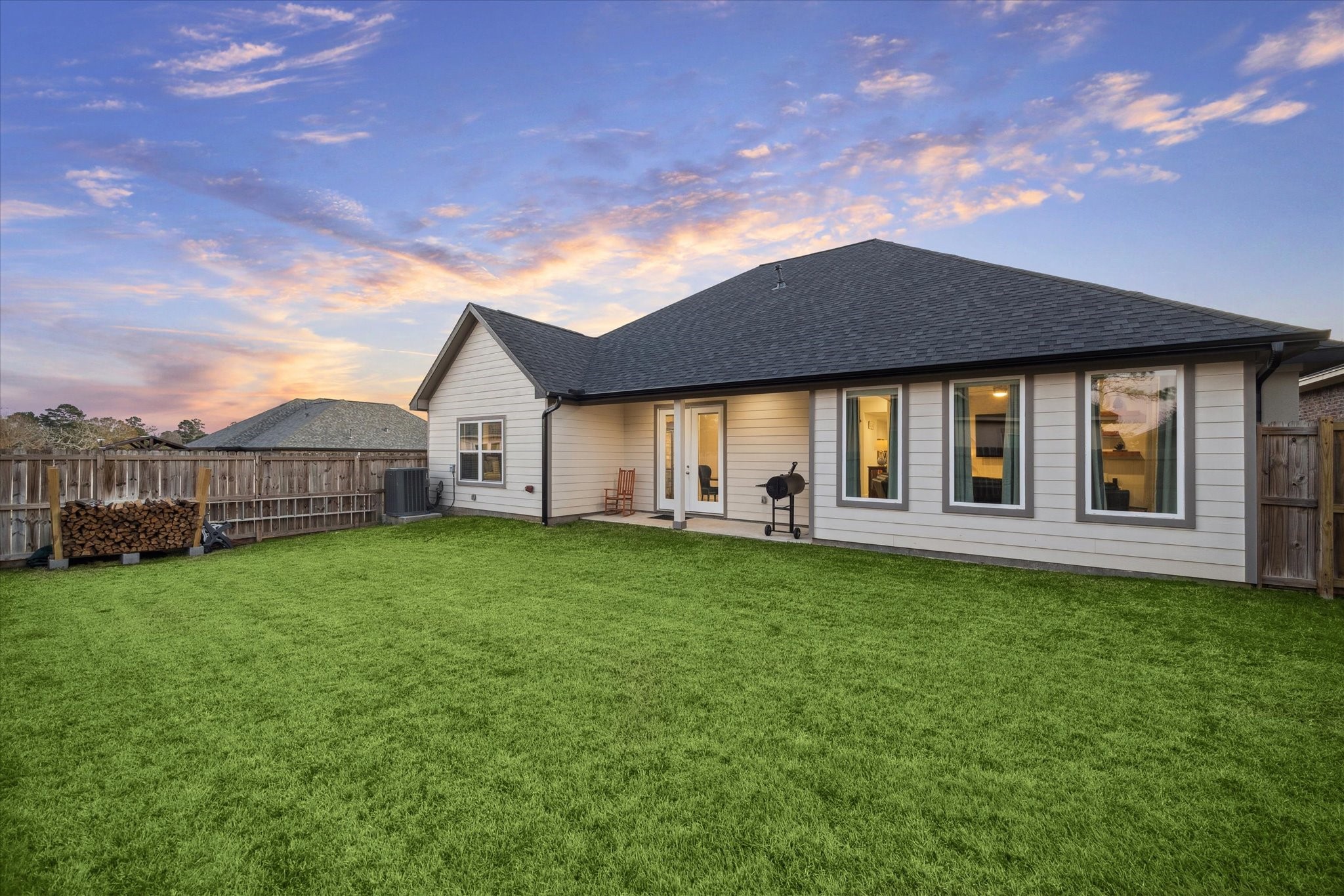 203 Hampton Glen Road Montgomery, TX 77356 - Photo 26 of 28 This angle of the right side of the patio highlights the corner-lot location, offering both privacy and convenience. The garage is positioned with access to the side street, providing ease for residents and guests.