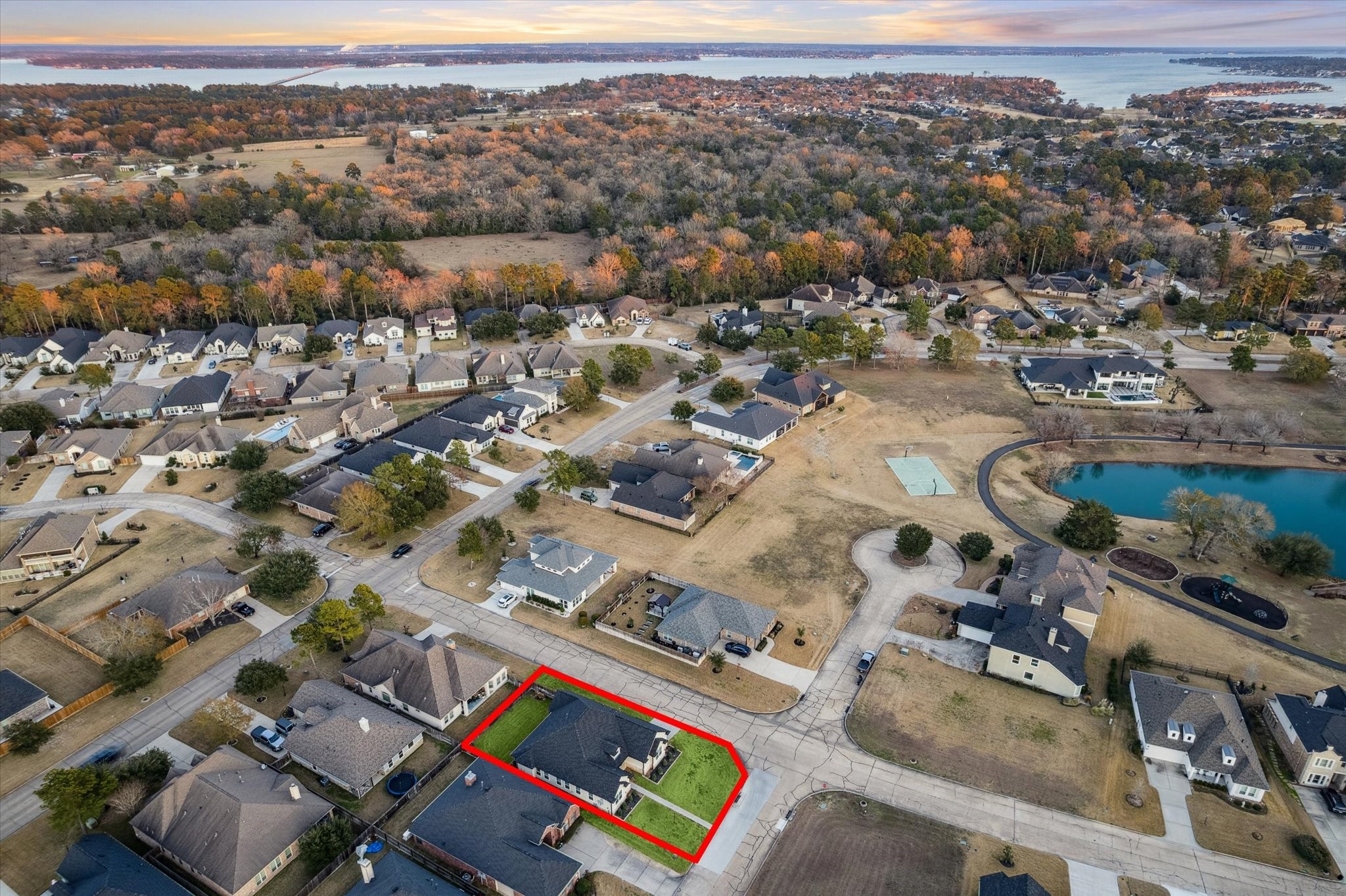 203 Hampton Glen Road Montgomery, TX 77356 - Photo 28 of 28 This aerial angle highlights the property’s prime location, conveniently situated near the pond. Set within a beautiful and well-established neighborhood, this home offers both charm and convenience.