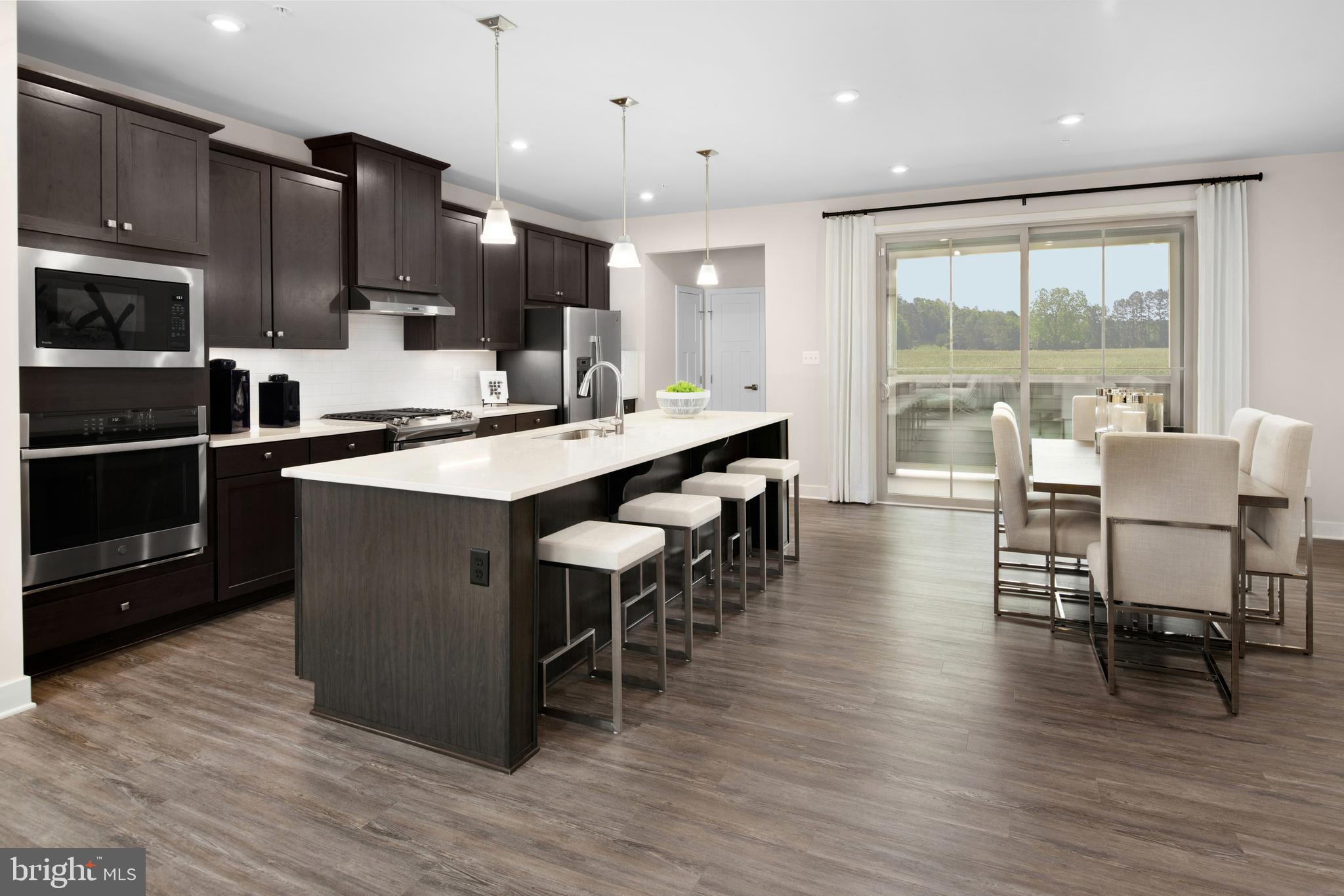 7928 Brandy Station Road, Unit SERENADE Hanover, MD 21076 - Photo 1 of 26 a large kitchen with stainless steel appliances a large island in the center