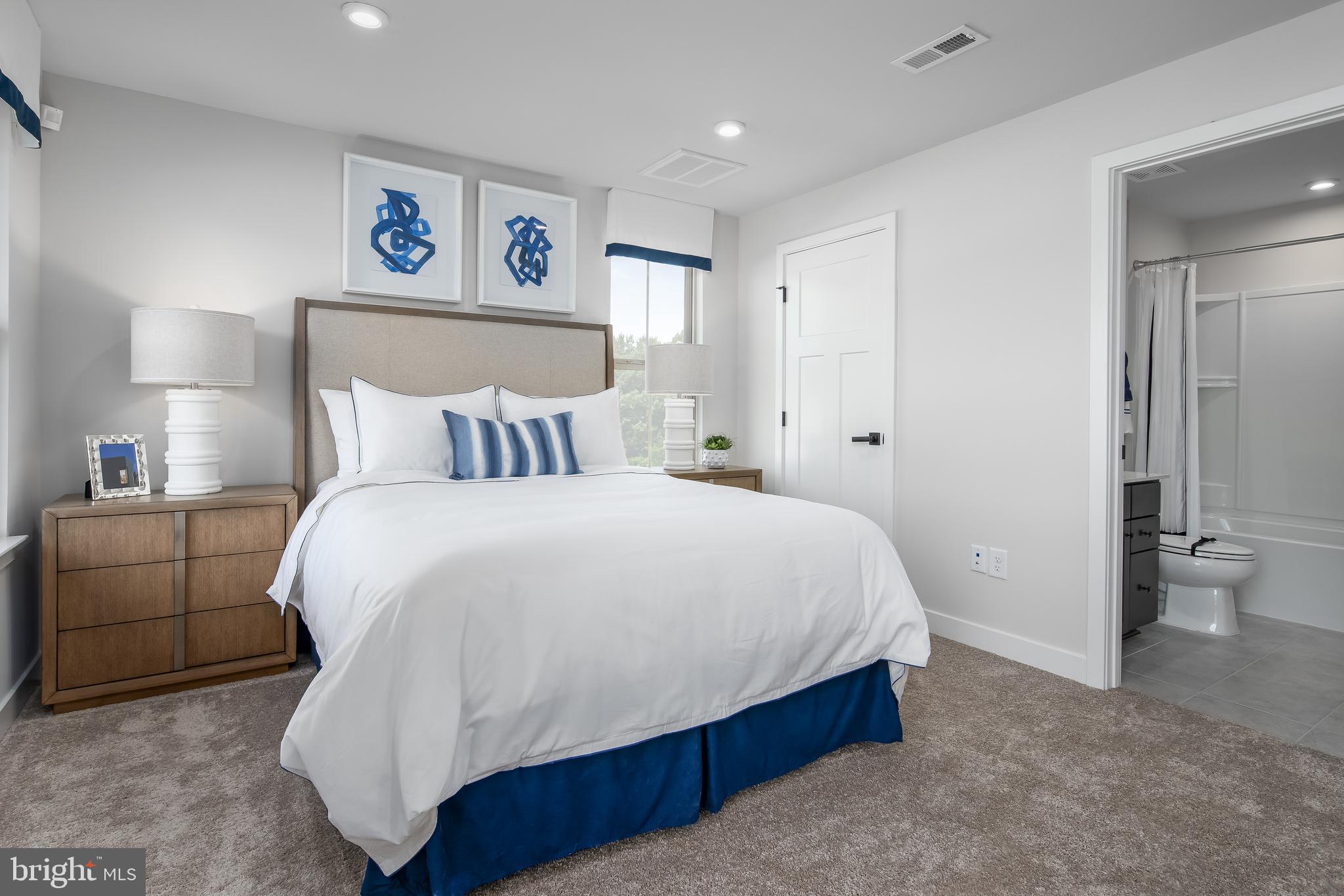 7928 Brandy Station Road, Unit SERENADE Hanover, MD 21076 - Photo 13 of 26 a bedroom with a bed and painting on the wall