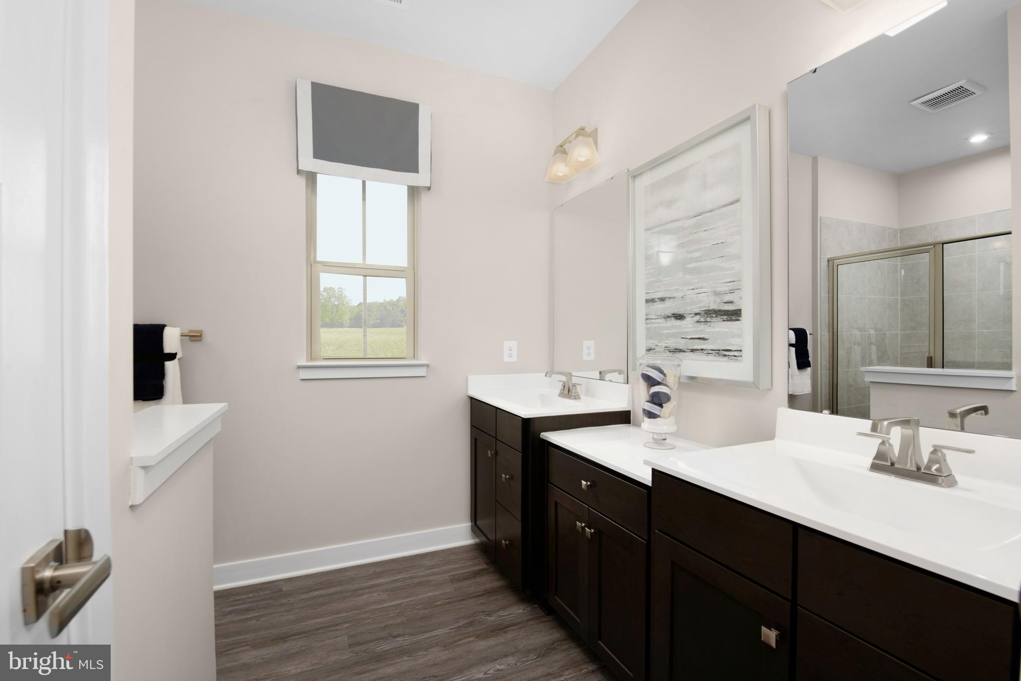 7928 Brandy Station Road, Unit SERENADE Hanover, MD 21076 - Photo 16 of 26 a bathroom with a double vanity sink and mirror