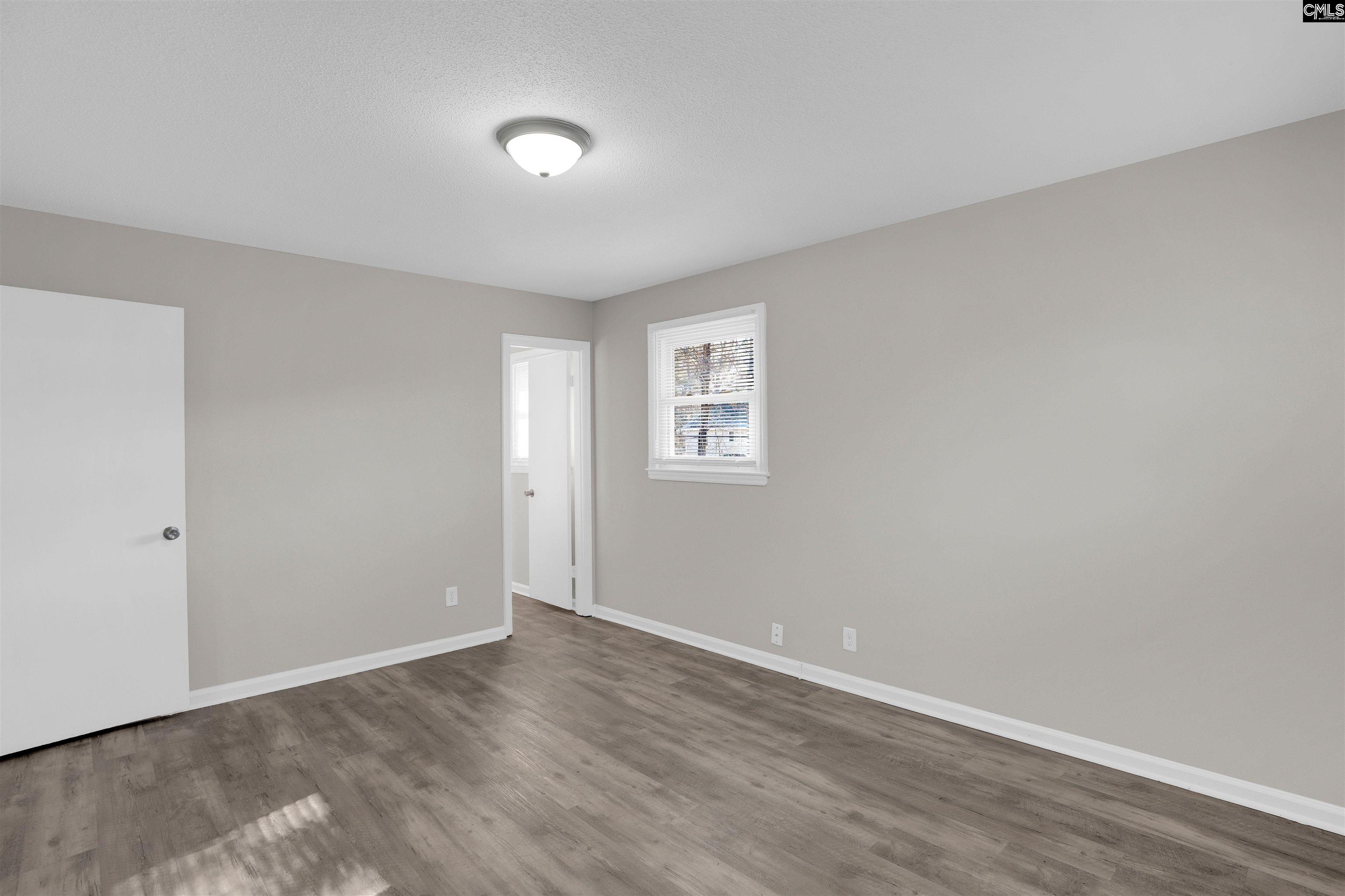 2620 Pleasant Ridge Drive Columbia, SC 29209 - Photo 25 of 37 a view of an empty room with wooden floor and a window