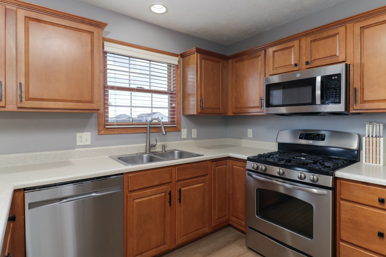 1820 Chuck Murray Drive Normal, IL 61761 - Photo 18 of 46 a kitchen with stainless steel appliances granite countertop a sink stove a microwave and cabinets