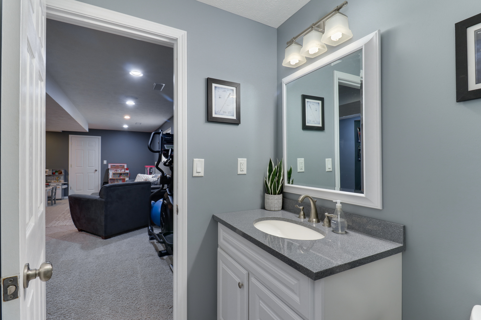 1820 Chuck Murray Drive Normal, IL 61761 - Photo 34 of 46 a bathroom with a granite countertop sink a mirror and a vanity