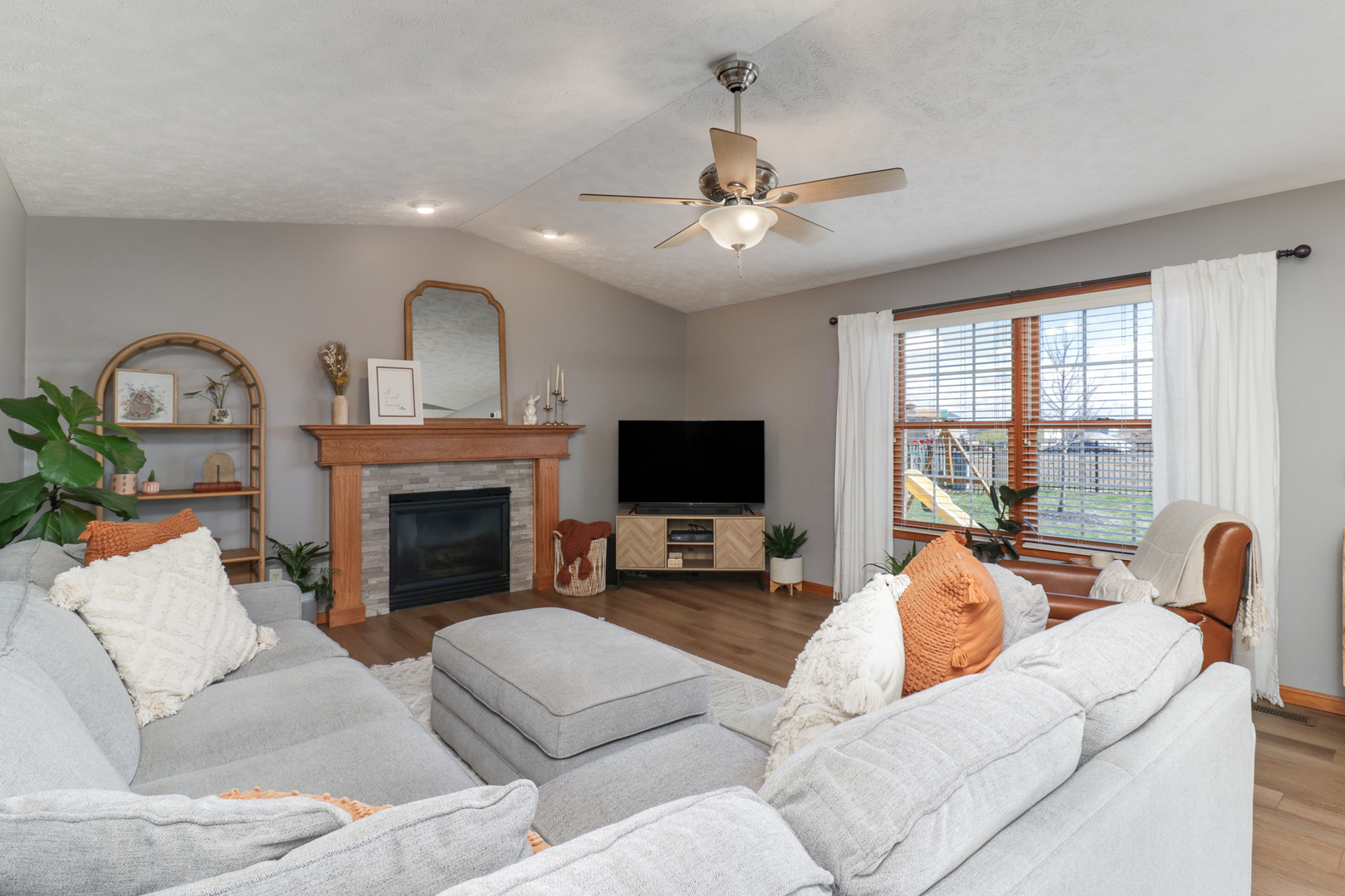 1820 Chuck Murray Drive Normal, IL 61761 - Photo 8 of 46 a living room with furniture a fireplace and a flat screen tv