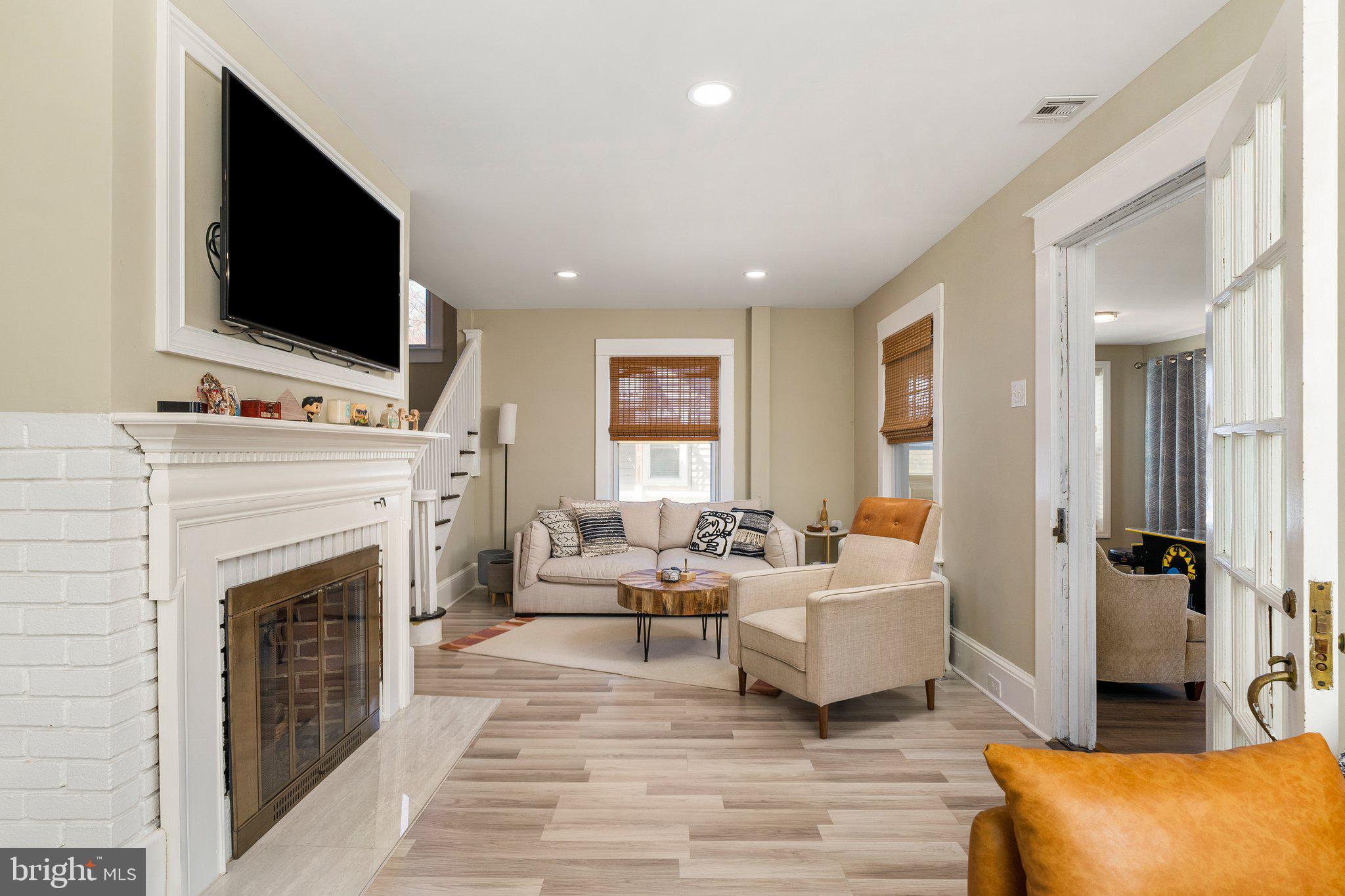 4053 Nottingham Way Hamilton, NJ 08690 - Photo 4 of 29 a living room with furniture a flat screen tv and a fireplace