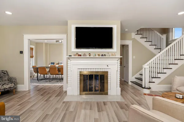a living room with furniture floor to ceiling window and wooden floor