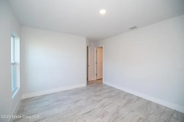 a view of an empty room and wooden floor