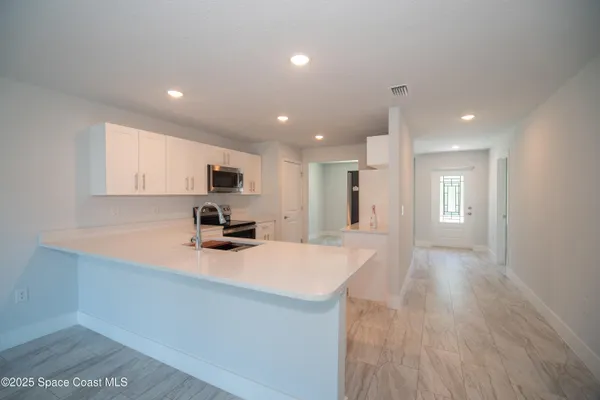 a kitchen with a refrigerator and a sink
