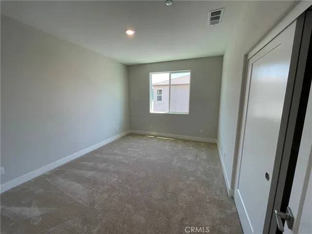 a room with a window and cabinets