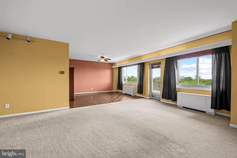 a view of a livingroom with an empty space and a window