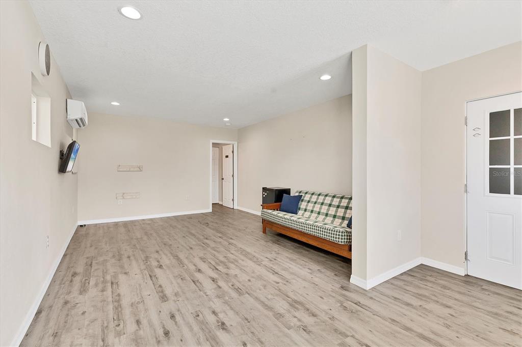 3045 Logue Road Myakka City, FL 34251 - Photo 12 of 32 a view of an empty room with wooden floor and windows