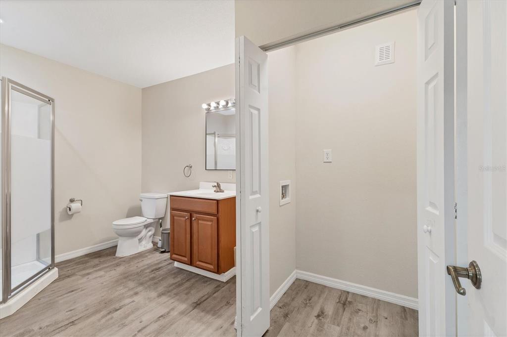 3045 Logue Road Myakka City, FL 34251 - Photo 12 of 31 a bathroom with a toilet a sink and mirror