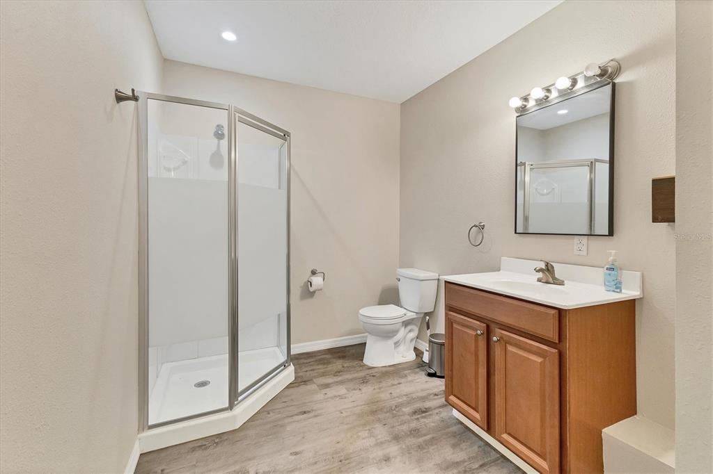 3045 Logue Road Myakka City, FL 34251 - Photo 13 of 31 a bathroom with a toilet a sink and mirror