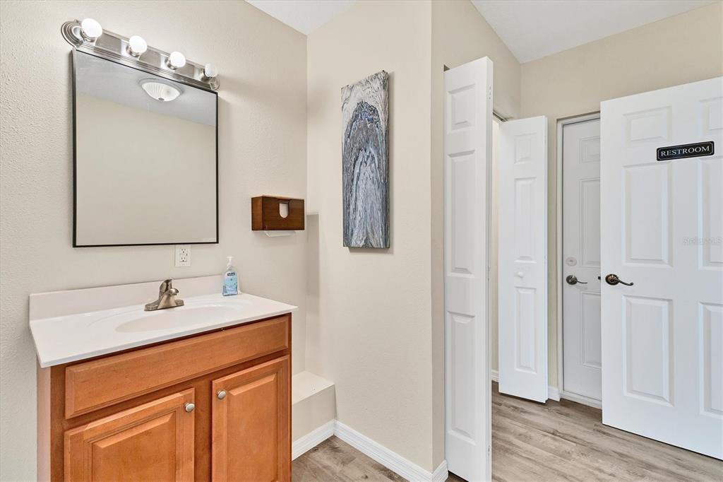 3045 Logue Road Myakka City, FL 34251 - Photo 16 of 32 a bathroom with a sink vanity and a mirror