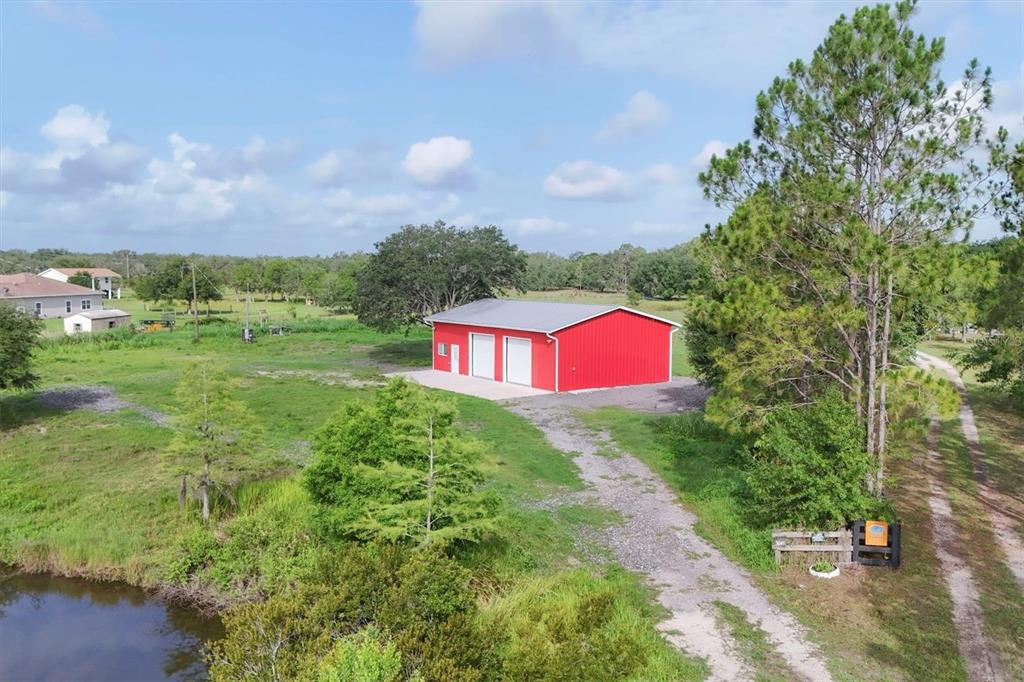 3045 Logue Road Myakka City, FL 34251 - Photo 2 of 31 a view of a yard with an outdoor space and deck