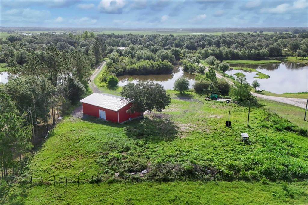 3045 Logue Road Myakka City, FL 34251 - Photo 25 of 32 an aerial view of a house with a yard and lake view