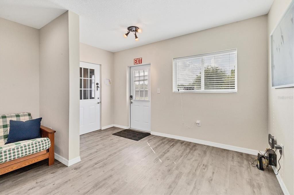 3045 Logue Road Myakka City, FL 34251 - Photo 3 of 32 a view of an empty room with a window and wooden floor