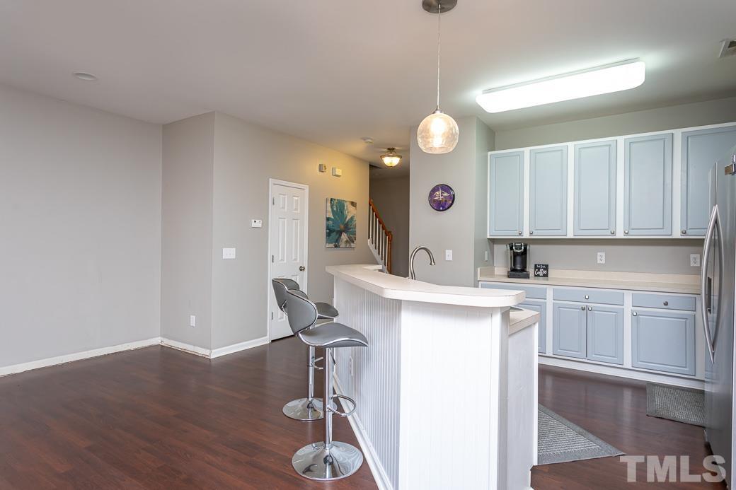 4439 Moss Garden Path Raleigh, NC 27616 - Photo 12 of 30 a kitchen with a sink cabinets and wooden floor