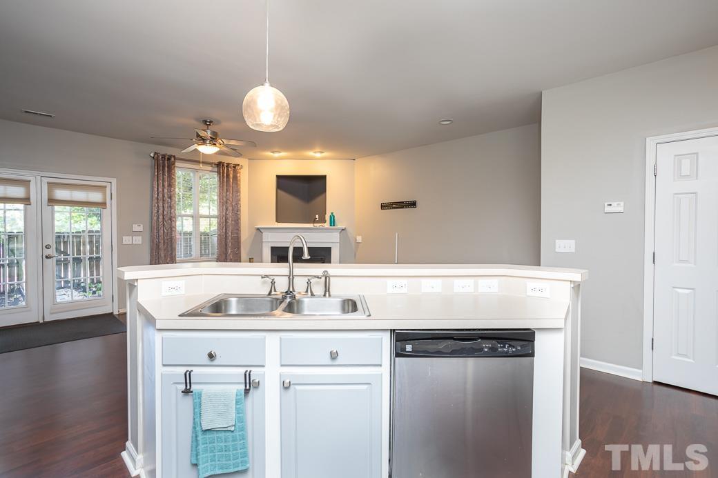 4439 Moss Garden Path Raleigh, NC 27616 - Photo 13 of 30 a room with kitchen island granite countertop a sink and a stove