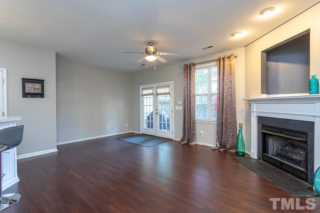 4439 Moss Garden Path Raleigh, NC 27616 - Photo 17 of 30 a view of an empty room with wooden floor and a fireplace