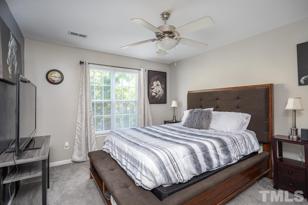 4439 Moss Garden Path Raleigh, NC 27616 - Photo 21 of 30 a bedroom with a large bed and a window