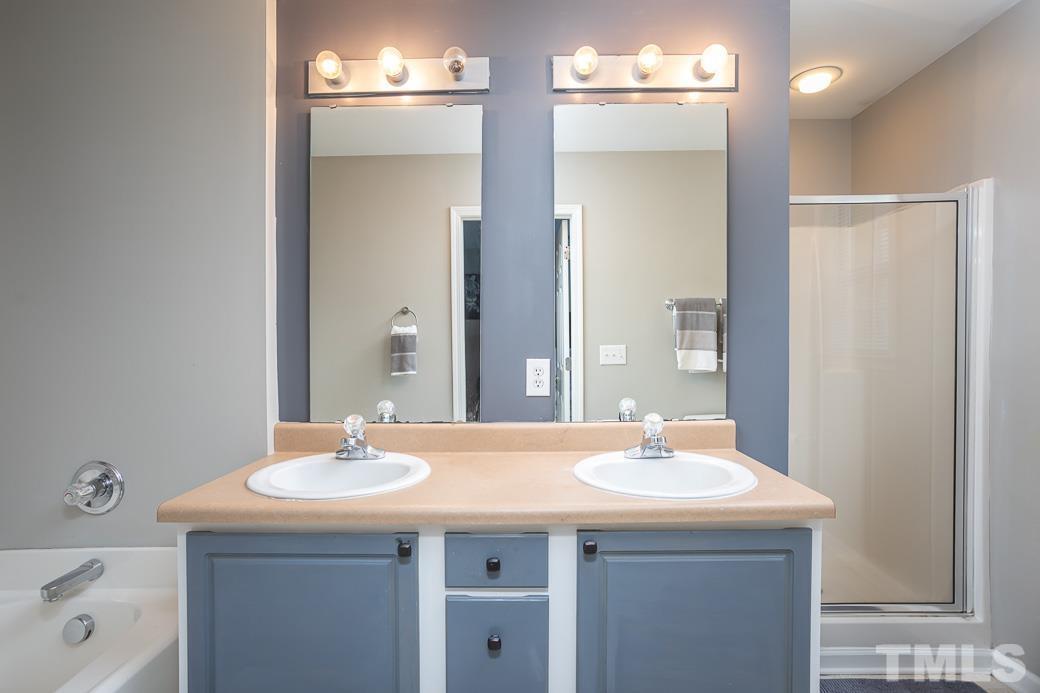 4439 Moss Garden Path Raleigh, NC 27616 - Photo 22 of 30 a bathroom with a sink and a mirror
