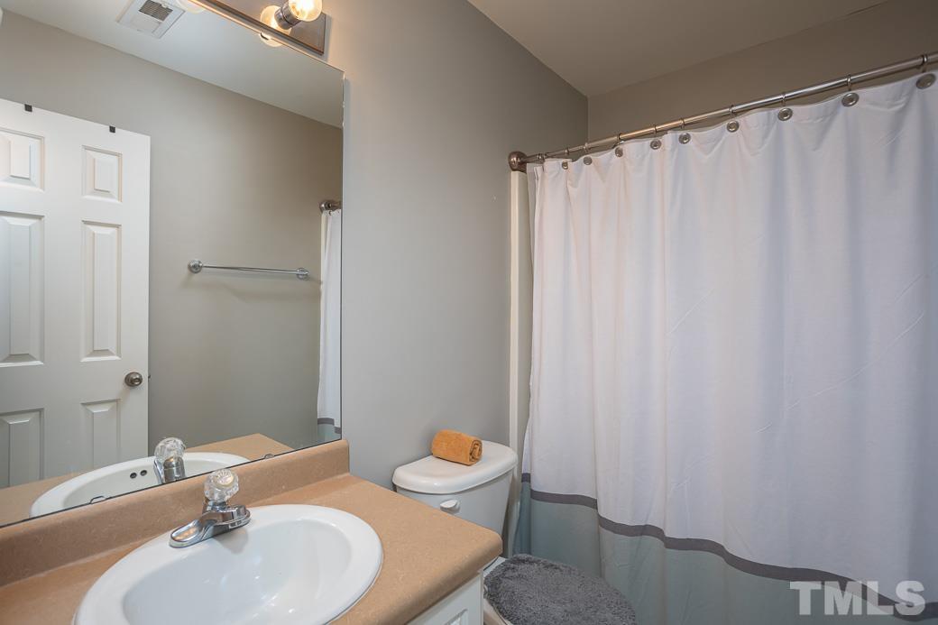 4439 Moss Garden Path Raleigh, NC 27616 - Photo 25 of 30 a bathroom with a sink and a mirror