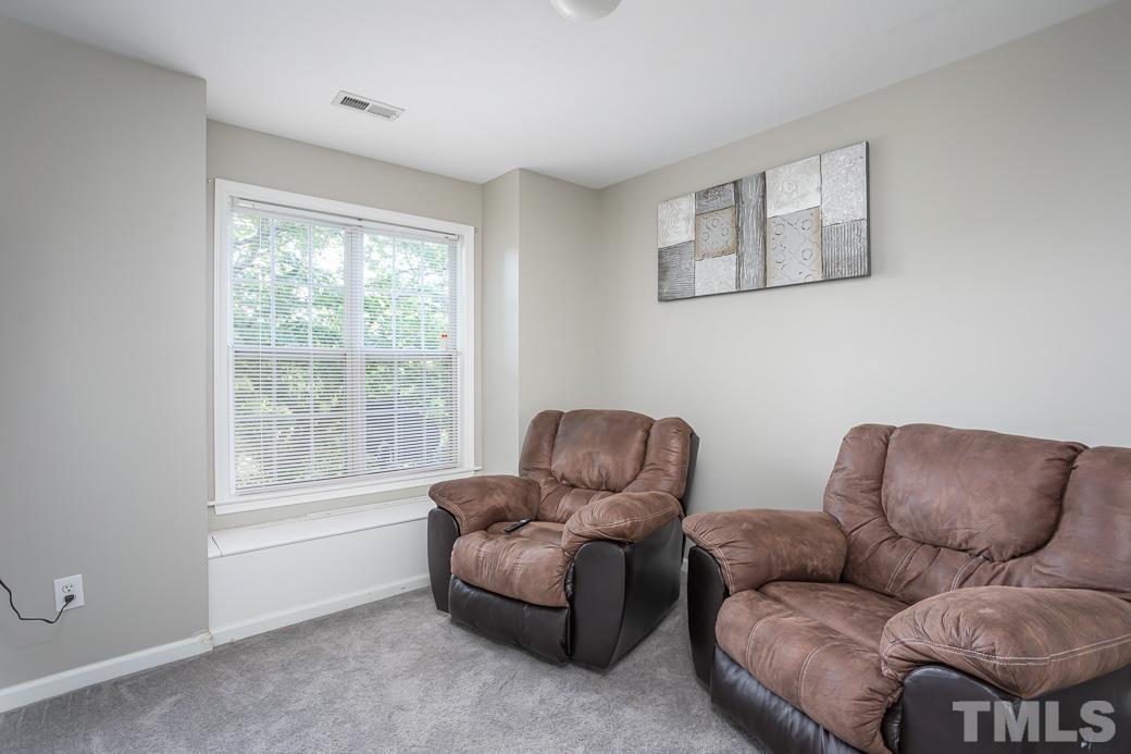 4439 Moss Garden Path Raleigh, NC 27616 - Photo 26 of 30 a living room with furniture and a window