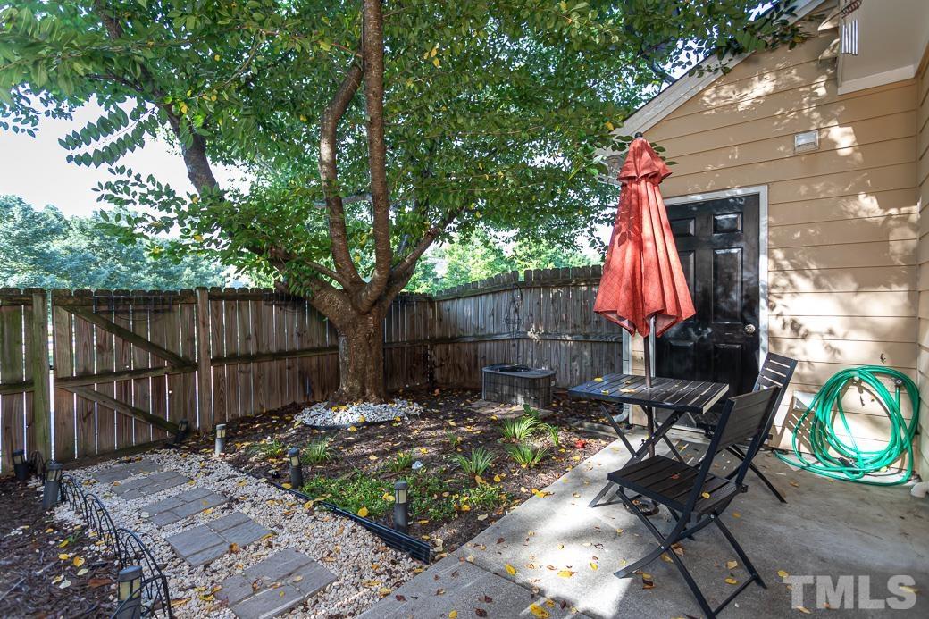 4439 Moss Garden Path Raleigh, NC 27616 - Photo 27 of 30 a view of a backyard with a small cabin and a chair