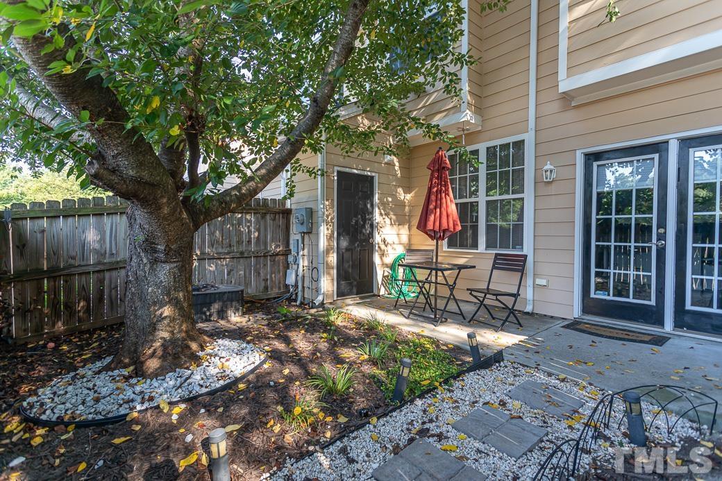 4439 Moss Garden Path Raleigh, NC 27616 - Photo 28 of 30 a view of a chair and table in backyard of the house
