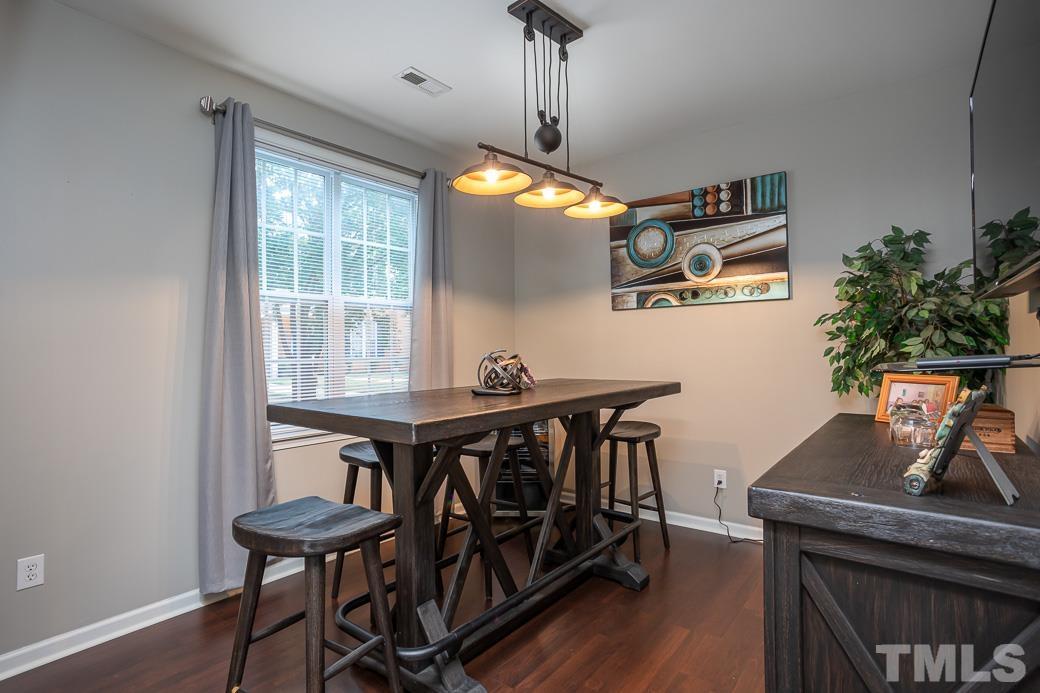 4439 Moss Garden Path Raleigh, NC 27616 - Photo 5 of 30 a view of a dining room with furniture and wooden floor