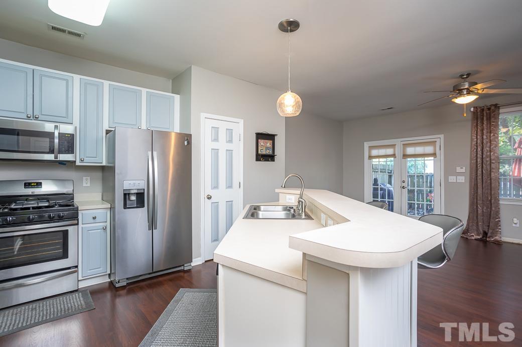 4439 Moss Garden Path Raleigh, NC 27616 - Photo 9 of 30 a kitchen with a sink a refrigerator and a stove