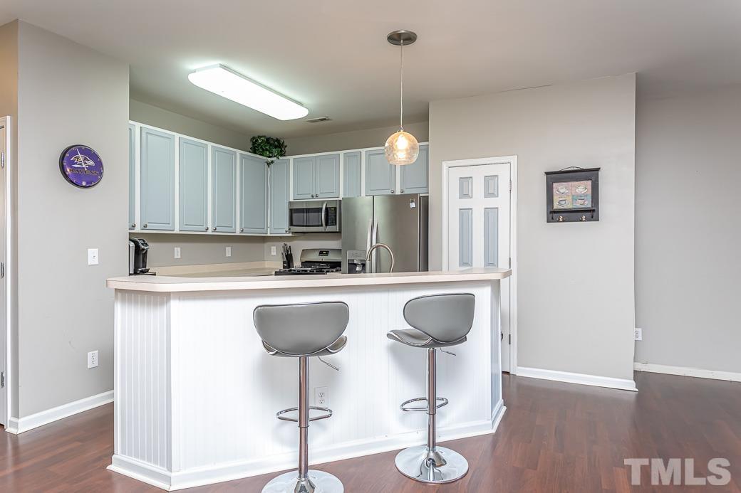 4439 Moss Garden Path Raleigh, NC 27616 - Photo 10 of 30 a kitchen with stainless steel appliances granite countertop a sink and a refrigerator
