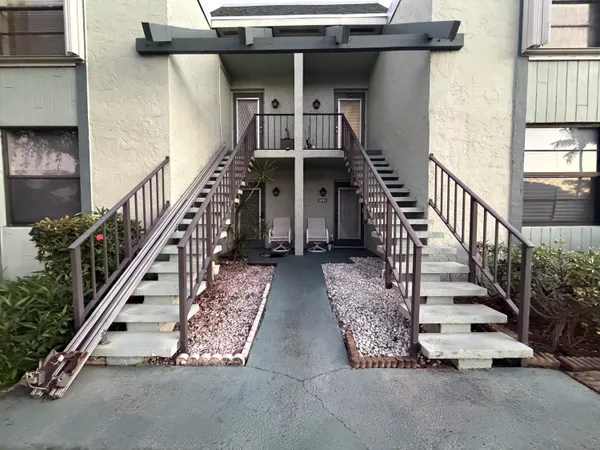 a view of entryway with wooden floor and stairs