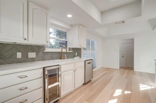 a kitchen with granite countertop white cabinets and white appliances