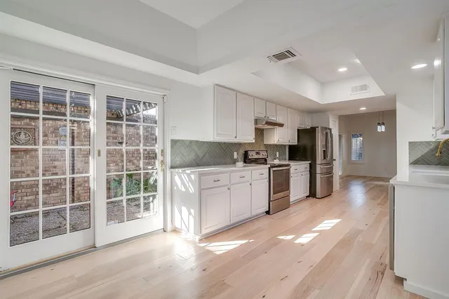 a kitchen with a refrigerator and a sink