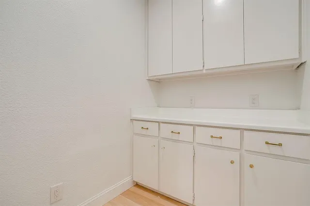 a view of white cabinets and window