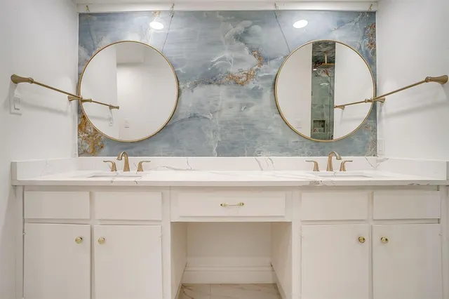 a bathroom with a double vanity sink and a mirror