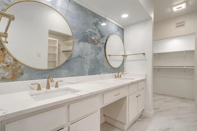 a bathroom with a double vanity sink and a mirror