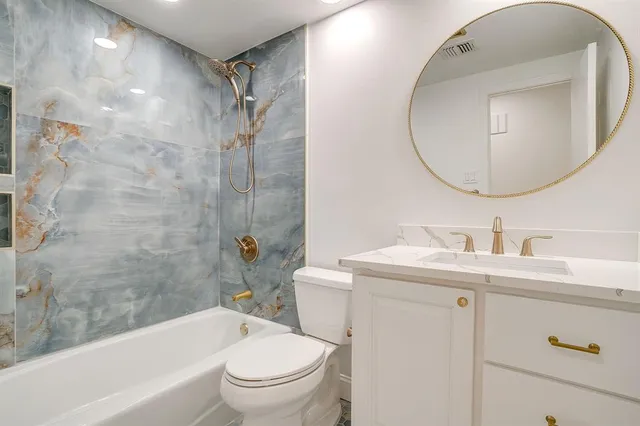 a bathroom with a sink a toilet and a mirror