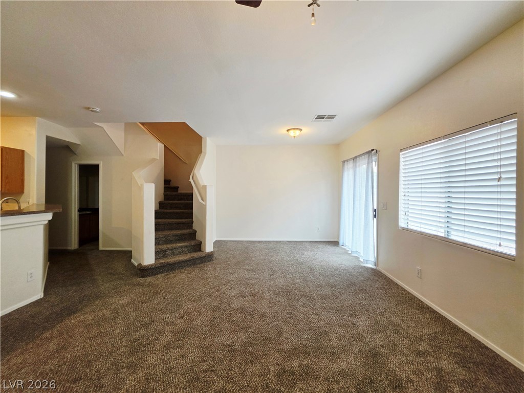 1571 Rusty Ridge Lane Henderson, NV 89002 - Photo 4 of 26 A welcoming interior offers a staircase and a bright window for abundant natural light.