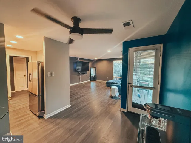 a view of a hallway view with wooden floor and staircase
