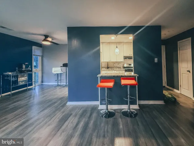 a room with wooden floor and furniture