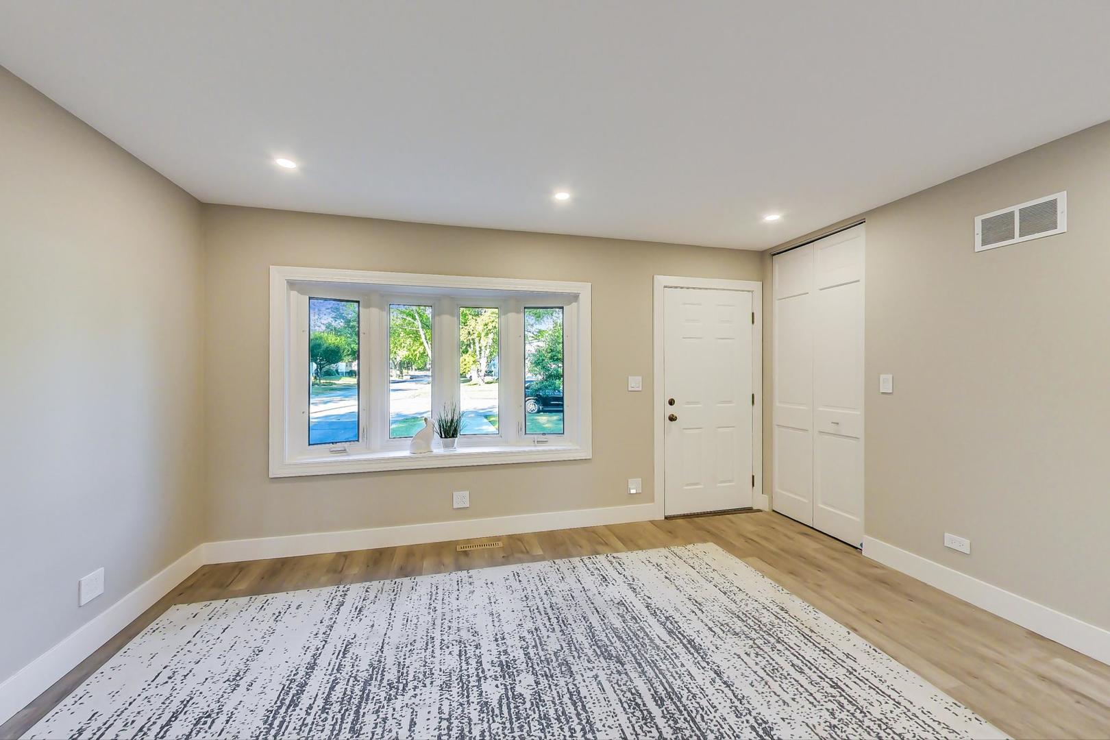 443 Raupp Boulevard Buffalo Grove, IL 60089 - Photo 3 of 21 a view of empty room with wooden floor and fan