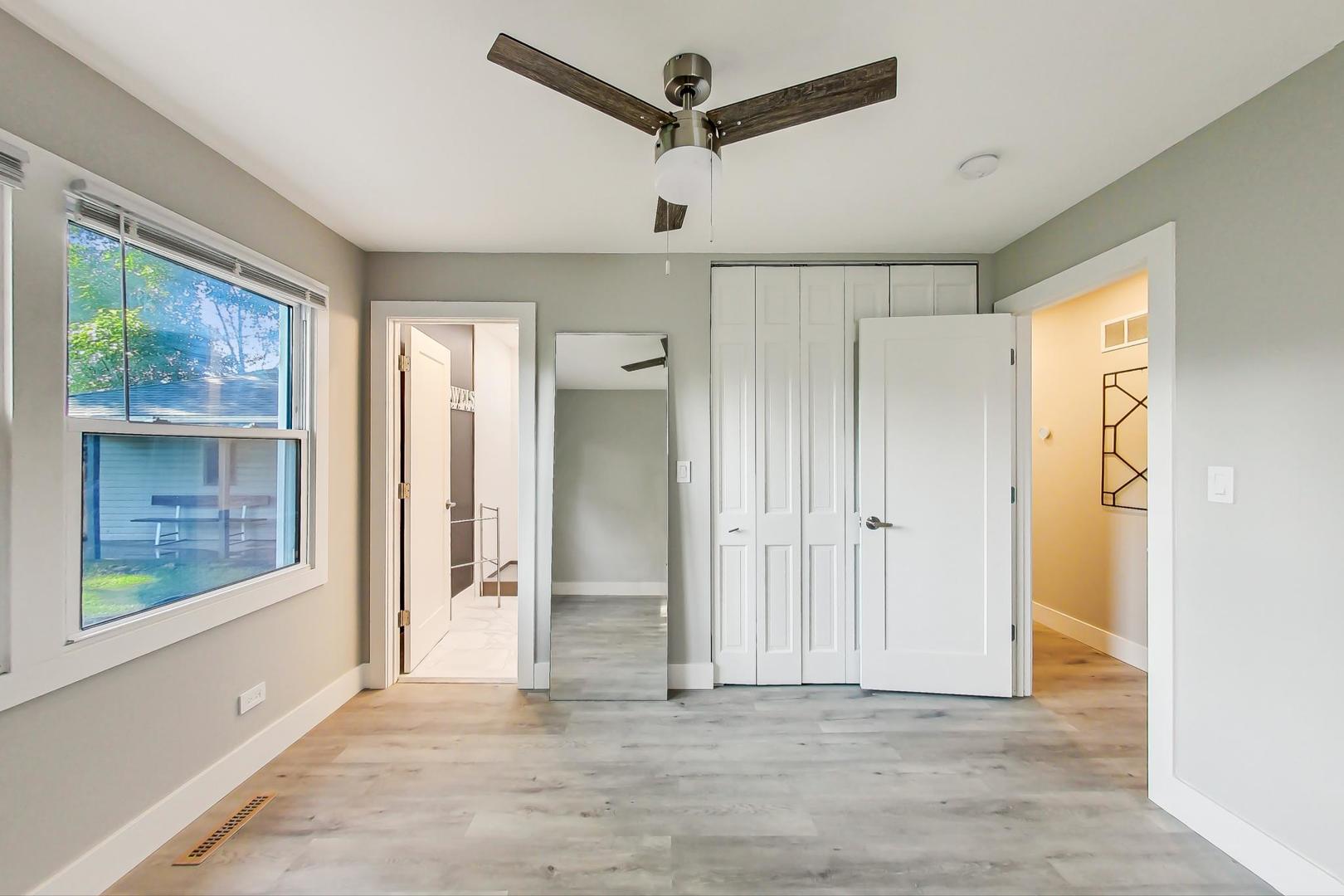 443 Raupp Boulevard Buffalo Grove, IL 60089 - Photo 7 of 21 a view of a livingroom with a ceiling fan & windows