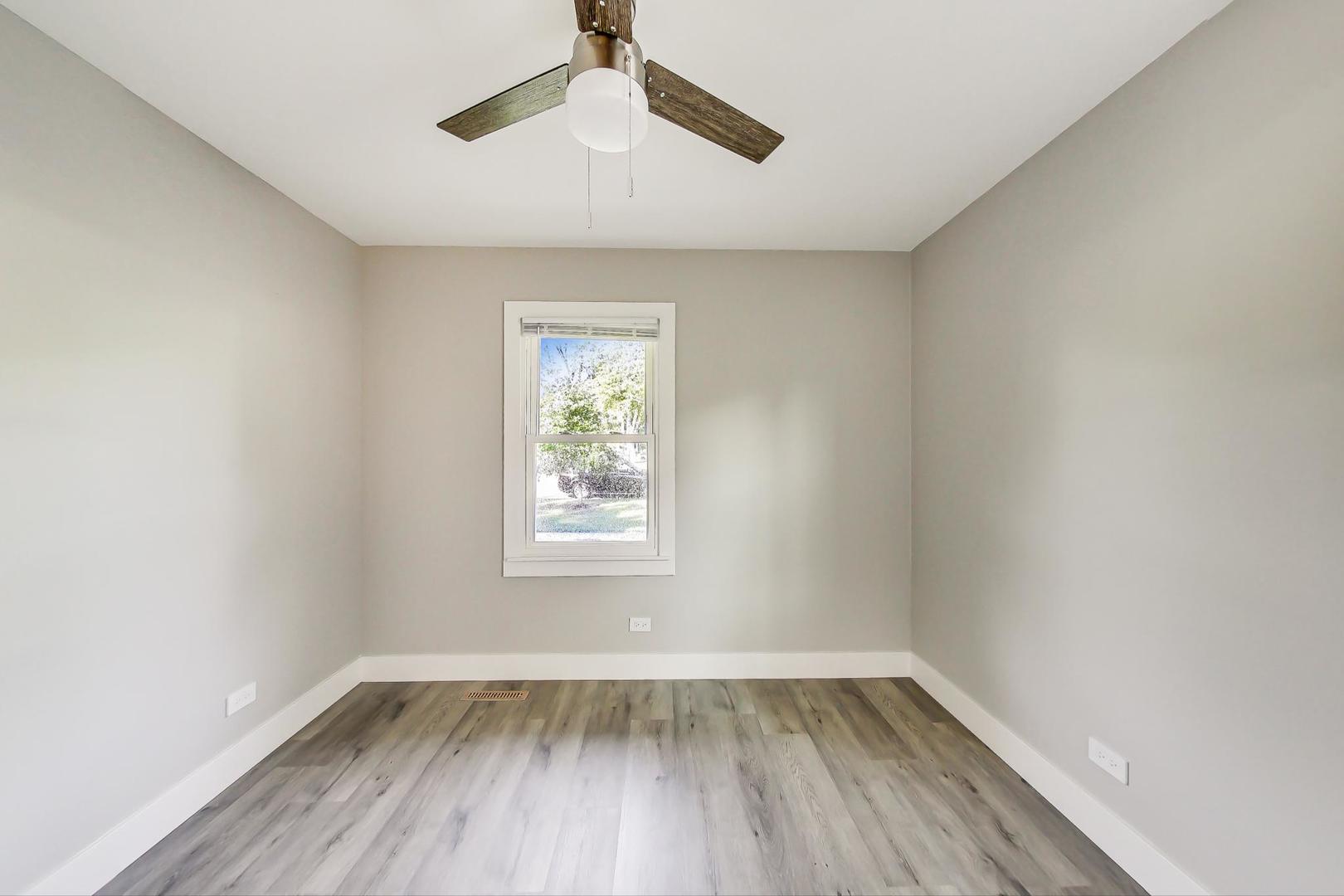 443 Raupp Boulevard Buffalo Grove, IL 60089 - Photo 9 of 21 an empty room with a window and wooden floor
