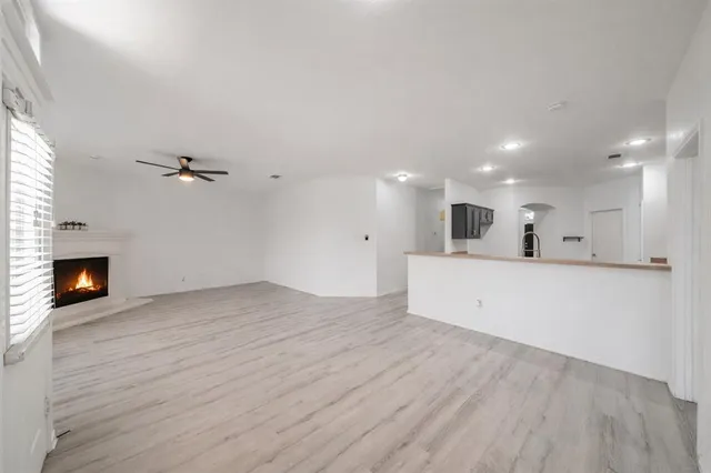 a view of a kitchen with an empty space and a fireplace