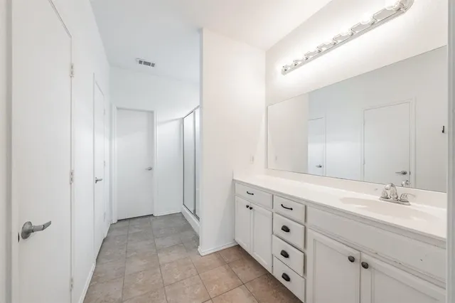 a spacious bathroom with a double vanity sink double and mirror